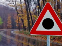 Red triangle road sign with a black dot: meaning and where to see it