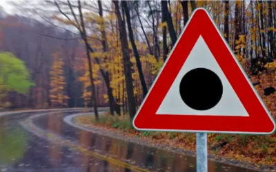 Red triangle road sign with a black dot: meaning and where to see it
